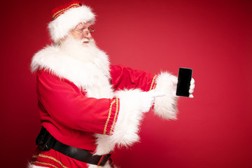 Santa Claus holding a mobile phone