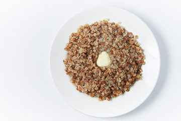 buckwheat in a white plate on a white background