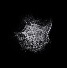 White solt powder explosion, flying pepper on black background, Freeze motion photo