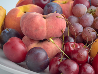 Isolate.Porcelain plate on a white background.On a plate lie juicy ripe fruit