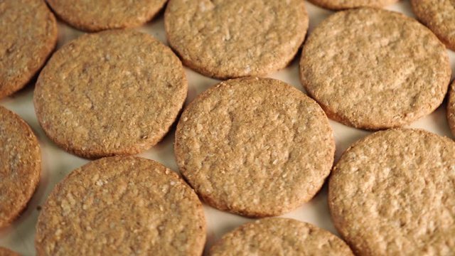 Rotation of oatmeal cookies on a wooden board. Making a healthy breakfast