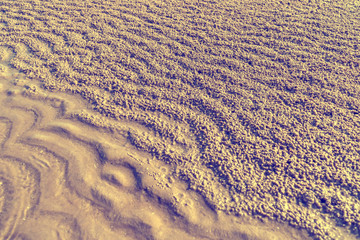 Waves on the sand and gravel nature texture