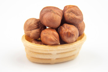 Different nuts in a waffle basket on a white background. Vitamin wholesome food.