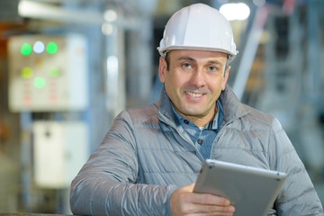 engineer with tablet working in factory