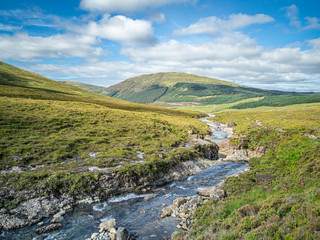 Isle of Skye scenery with a stream and blue sky