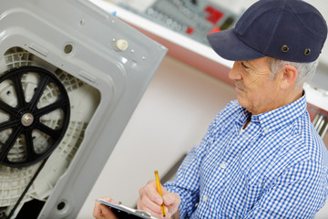 man looks at washing machine in store