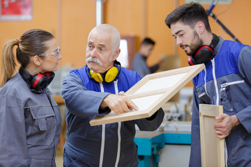 teacher pointing to imperfection on female apprentices creation