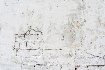 texture of a white wall with a damaged stucco layer, architecture abstraction background