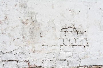 texture of a white wall with a damaged stucco layer, architecture abstraction background
