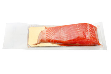 Red fish in a vacuum on a white background. Vacuum-packed salmon close-up.