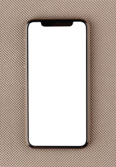 Smartphone with a blank white screen. New popular smartphone on a gray surface.