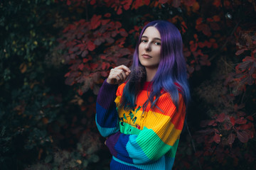 Naklejka premium Teenager with violet hair in colorful sweater.