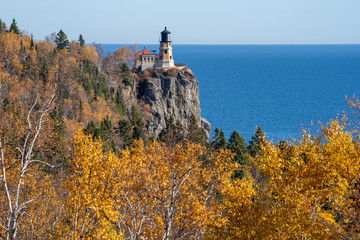 Fototapeta na wymiar Autumn fall leaves with Split Rock Lighthouse in the distance on Lake Superior Minnesota