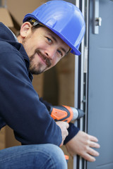 happy builder installing wooden blinds