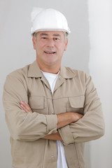 portrait of young architect standing with arms crossed and smiling