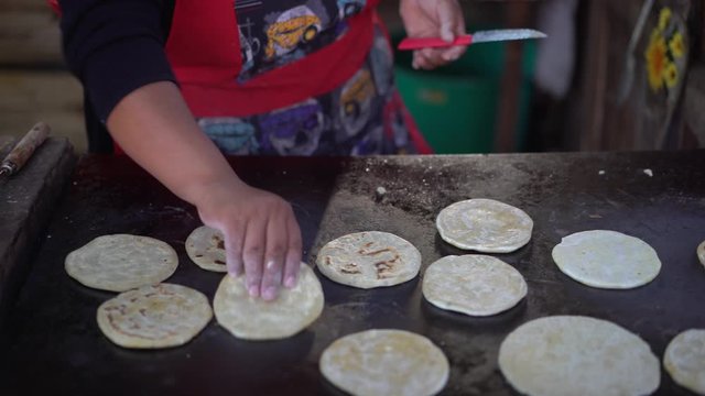 Making typical delicious flour tortillas on grill. Traditional dish of Central and Latin america