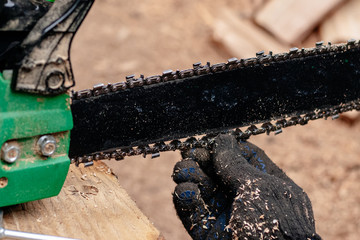 Professional technician working by repair service.Repairing chainsaw in repair shop.