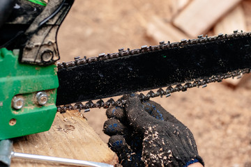 Professional technician working by repair service.Repairing chainsaw in repair shop.