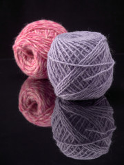 Balls of colored thread on the surface of the glass.On dark background