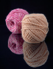 Balls of colored thread on the surface of the glass.On dark background