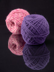 Balls of colored thread on the surface of the glass.On dark background