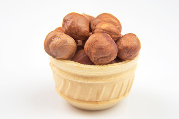Different nuts in a waffle basket on a white background. Vitamin wholesome food.