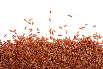 Red rice scattered on white background. Heap of uncooked dry rice grains, top view