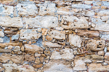 Close up old partially destroyed stonewall texture