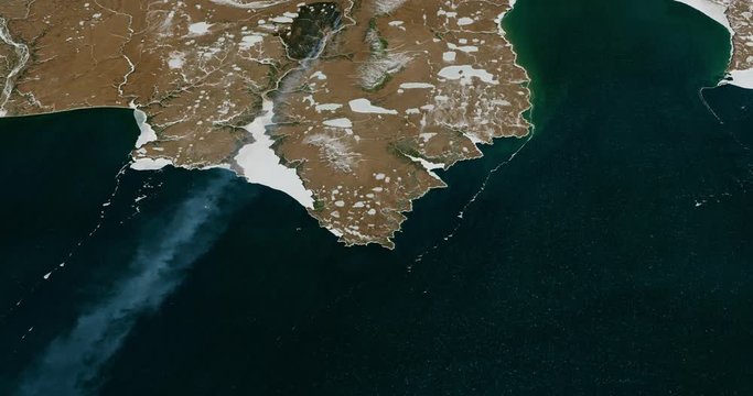 Very high-altitude circular tracking shot of Gizhigin Bay, south coast of Siberia. Reversible, seamless loop. Elements of this image furnished by NASA