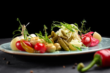 Marinated vegetables with mushrooms on a dark background