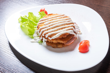 Potato pancakes with ham and herbs.