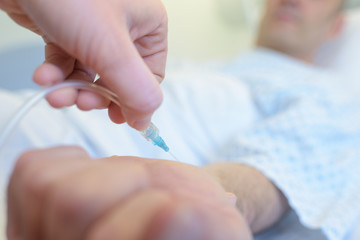 close up syringe on arm for blood draw services