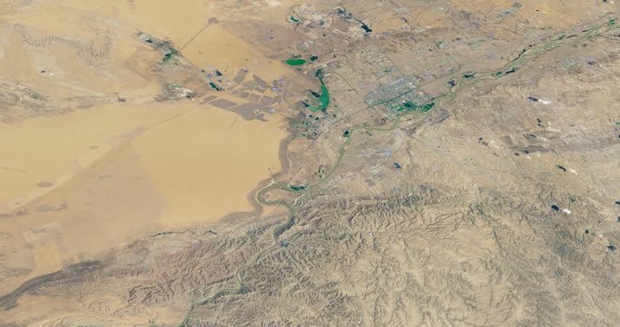 Very high-altitude circular tracking shot of Tengger Desert Solar Park, China's northwestern Ningxia province. Reversible, seamless loop. Elements of this image furnished by NASA