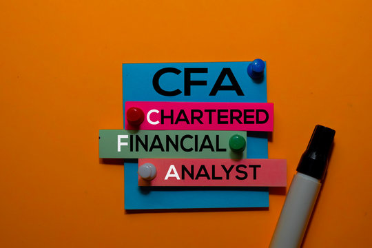 CFA. Chartered Financial Analyst acronym on sticky notes. Office desk background
