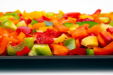 Sliced ​​colored bell peppers on a plate. Vitamin healthy food.