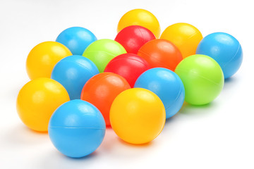 Colored plastic balls on white background