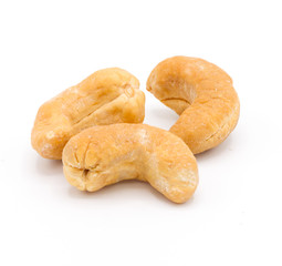 Cashew nuts baked on a white background.