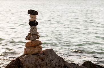 Fototapeta na wymiar A Cairn, a ceremonial stack of rocks on a rocky sore on a Gulf Coast Florida beach.