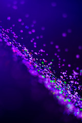 Colorful lights blurred glitter background. Abstract illuminated texture. Christmas, new year or...