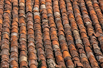 Old red tiles roof background, house roof.