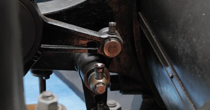 Moving gears of a vintage machine driven by steam engine