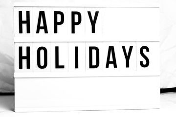 Happy Holidays displayed on a vintage Retro Lightbox. Flat Lay Concept image