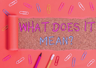 Word writing text What Does It Mean question. Business photo showcasing intended to communicate unclear statement Stationary and torn cardboard placed above a wooden classic table backdrop