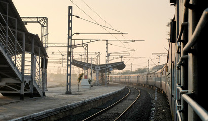 Indian railway train,at station platform,view from window at dawn,Tamil Nadu,India.