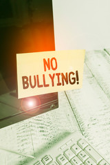 Word writing text No Bullying. Business photo showcasing stop aggressive behavior among children power imbalance Notation paper taped to black computer monitor screen near white keyboard