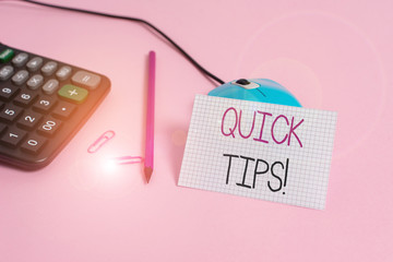 Handwriting text Quick Tips. Conceptual photo small but particularly useful piece of practical advice Wire mouse clips marker calculator squared paper sheet colored background