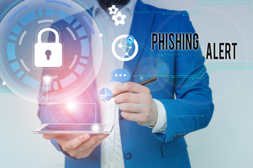 Writing note showing Phishing Alert. Business concept for aware to fraudulent attempt to obtain sensitive information Male human wear formal suit presenting using smart device