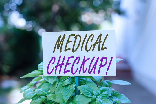 Handwriting text writing Medical Checkup. Conceptual photo thorough physical examination includes variety of tests Plain empty paper attached to a stick and placed in the green leafy plants