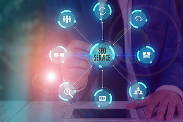 Writing note showing Seo Service. Business concept for techniques and procedures to increase the...