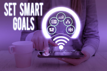 Writing note showing Set Smart Goals. Business concept for giving criteria to guide in the setting of objectives Picture photo network scheme with modern smart device